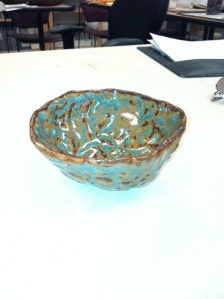 Pinch pot tea bowl with Pat's oil spot glaze on it.